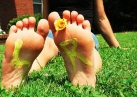 Feet without a mushroom with a flower between the fingers